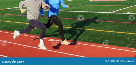 Two Fast Runners Training Together on a Track Stock Image - Image of ...