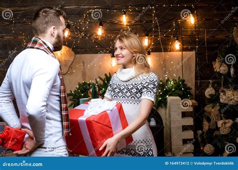 Positive Delighted Loving Couple Giving Each Other Christmas Gifts ...