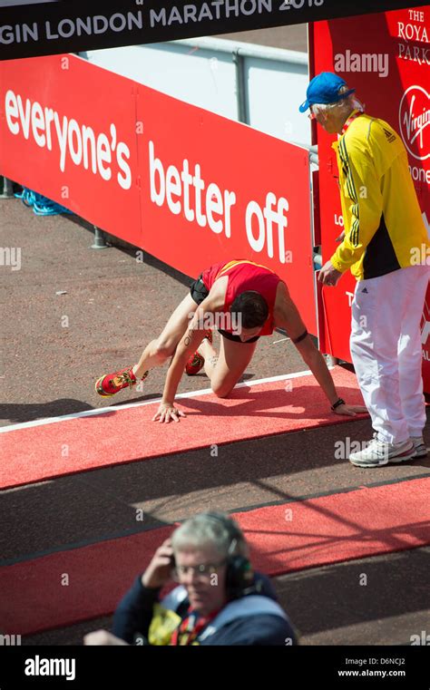 A runner collapses and crawls over the finish line of the 2013 Virgin ...