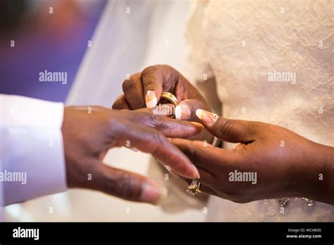 Rings exchange for black couple marriage ceremony Stock Photo - Alamy