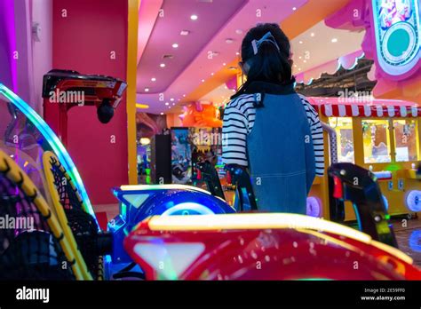 Children in shopping mall play zone with neon light Stock Photo - Alamy