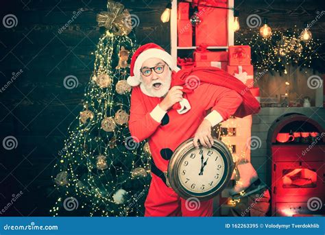 New Year and Christmas Time. Santa Claus Shows on the Clock. Happy ...