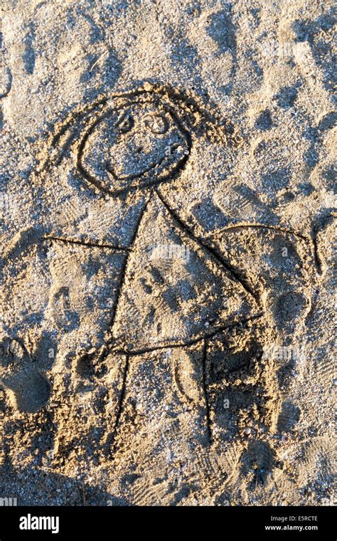 Child's drawing in the sand representing a woman Stock Photo - Alamy