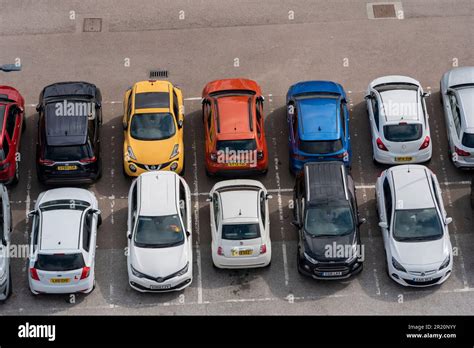 Cars parked in a car park, viewed from above. Marked out parking bays ...