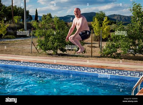 Older man having fun in a swimming pool Stock Photo - Alamy