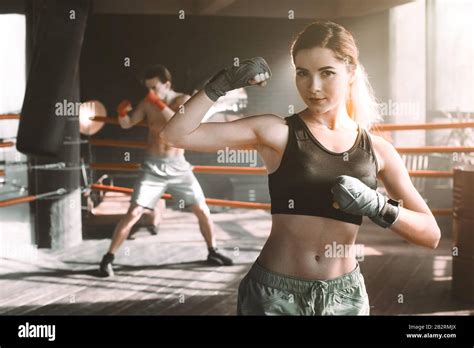 Female boxer doing shadow boxing inside a boxing ring. Boxer practicing ...