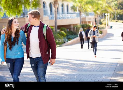 Student Couple Walking Outdoors On University Campus Stock Photo - Alamy
