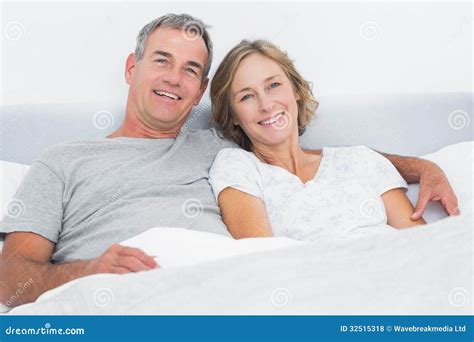 Couples Heureux Caressant Dans Le Lit Regardant L'appareil-photo Photo ...