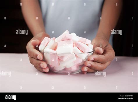 marshmallow candy in a bowl on blue Stock Photo - Alamy
