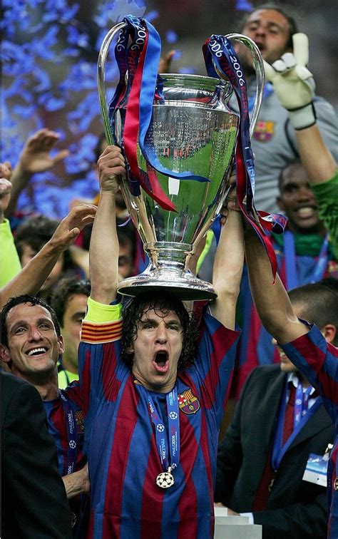 PARIS - MAY 17: Carles Puyol of Barcelona carries the trophy in ...