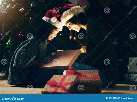 Mother, Child and Opening Christmas Gift Together at Night, Excited and ...