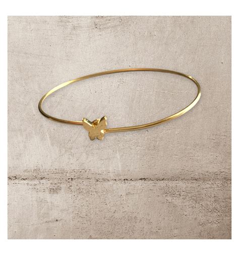 Bracelet jonc en acier inoxydable doré avec un petit papillon