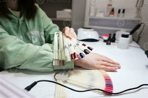 Manicure master working with female client in beauty salon. Woman ...
