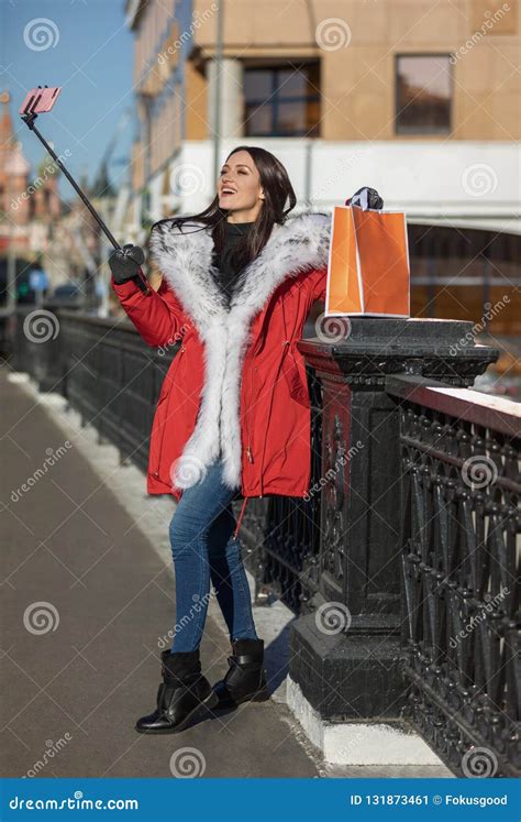 Blogger Girl in Red Warm Jacket with a Smartphone Stock Image - Image ...