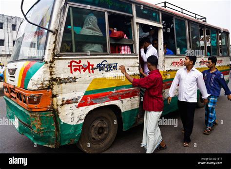 Passengers boarding a ramshackle overcrowded public bus in central ...