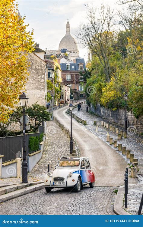 A Vintage French Car Driving Down a Narrow Street of Montmartre ...