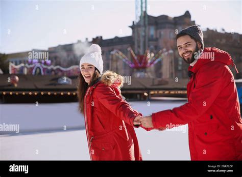 Lovely couple spending time together at outdoor ice skating rink Stock ...