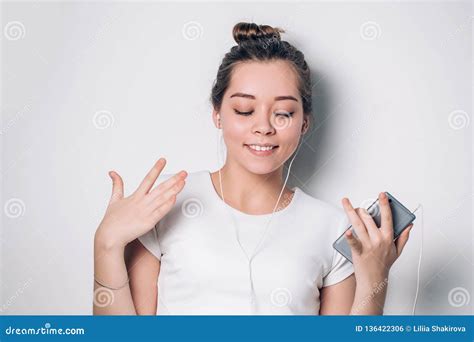 Excited Girl Dancing and Listening Music with Headphones and Smart ...