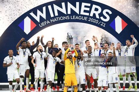 TOPSHOT - French players celebrate with the trophy at the end of the ...
