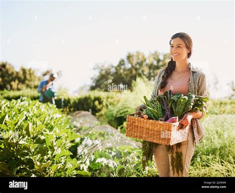 Bringing in a bountiful harvest. Shot of a happy young farmer ...