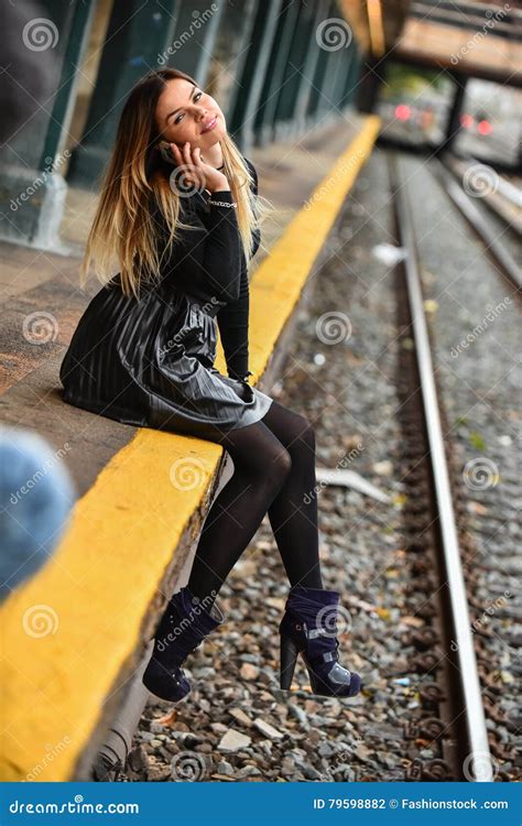 Pretty Young Girl Sitting on the Train Platform. Stock Photo - Image of ...