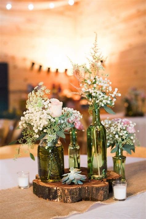 Old Glass Bottles Jars Candles And Wooden Slice Used For Wedding