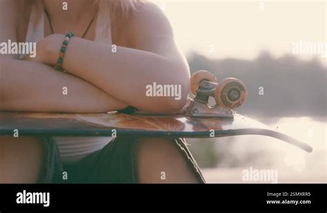 Teen Skater Girl S Sunset Reflection Close Up Skateboard On Knees