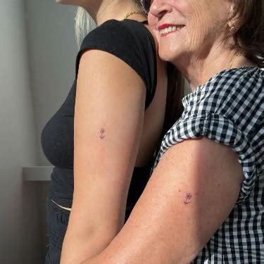 Mother Daughter Bond Matching Small Flower Tattoos On The Upper Arm