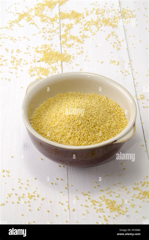 Bowl On White Wood Filled With Organic Millet Stock Photo Alamy