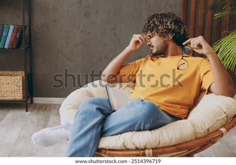 Dark Skinned Indian Man With Glasses Reading Book Royalty Free Images