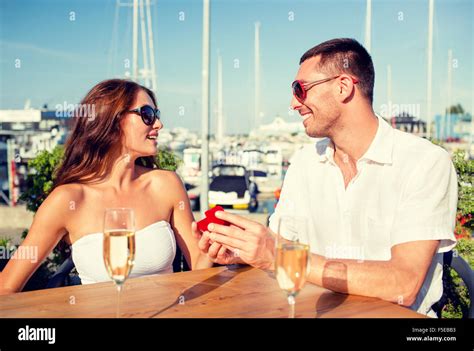 Smiling Couple With Champagne And Gift At Cafe Stock Photo Alamy