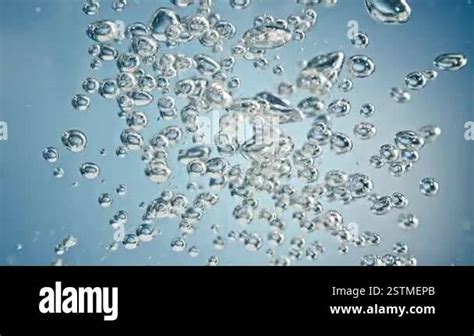 Super Slow Motion Shot Of Air Bubbles Rising Up In Water On Light Blue