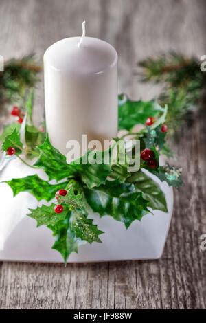 Burning Candle And Christmas Decorations On Wooden Table On Dark