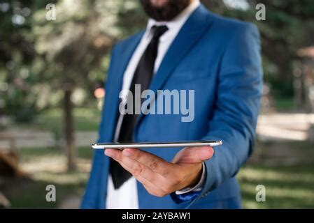 Smiling Man Holding His Mobile Phone Stock Photo Alamy