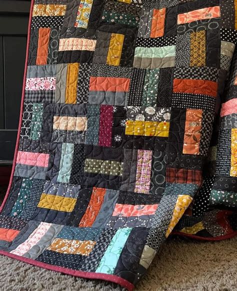 A Quilted Blanket Sitting On Top Of A Bed