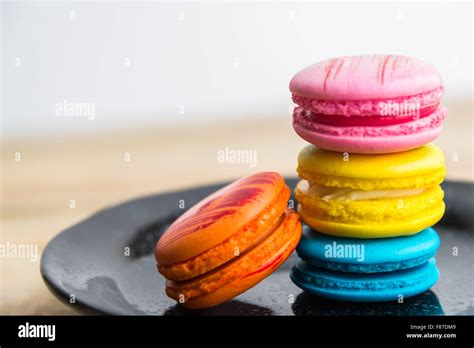 Colorful Macaroon In Black Dish On Wooden Floor Stock Photo Alamy