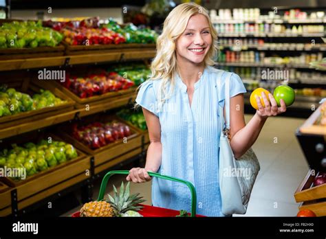 Smiling Woman Holding Apples Stock Photo Alamy