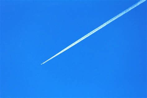 Premium Photo Low Angle View Of Vapor Trail Against Clear Blue Sky