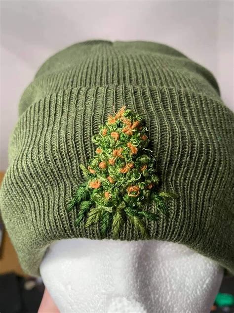 Green Knitted Hat With Orange Flower