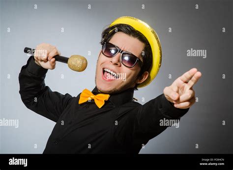 Funny Man With Mic In Karaoke Concept Stock Photo Alamy