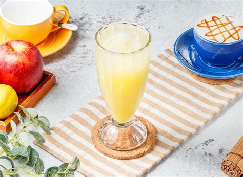 Premium Photo Iced Kumquat Lemon Tea In A Glass On Mat With Grey Background Breakfast Drink