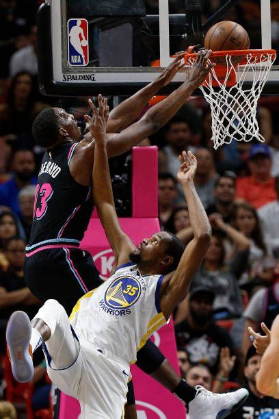 Bam Adebayo of the Miami Heat dunks over Kevin Durant of the Golden ...