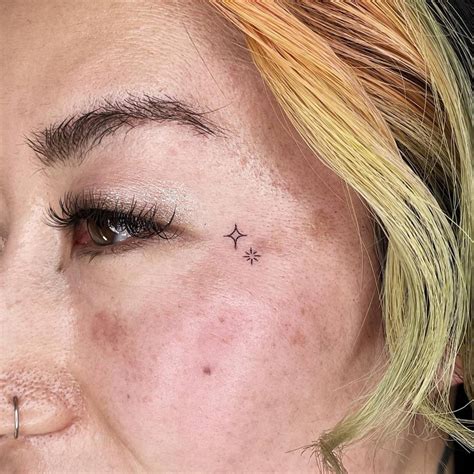 Tiny Stars Tattoo Located On The Face Minimalistic