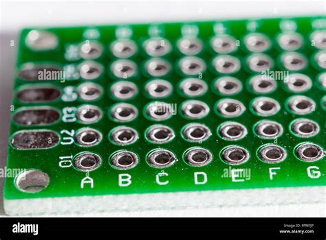 A Blank Green Prototyping PCB Board With Copper Hole Closeup Stock