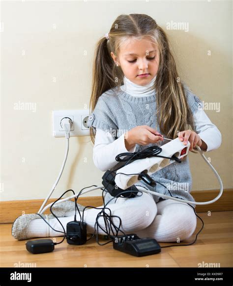 Risky Little Girl Dangerously Playing With Sockets And Electricity