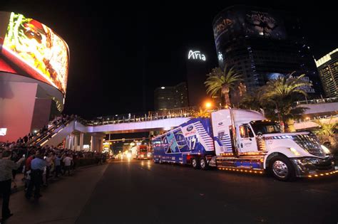 Fans watch hauler trucks on Wednesday during their annual parade up the ...