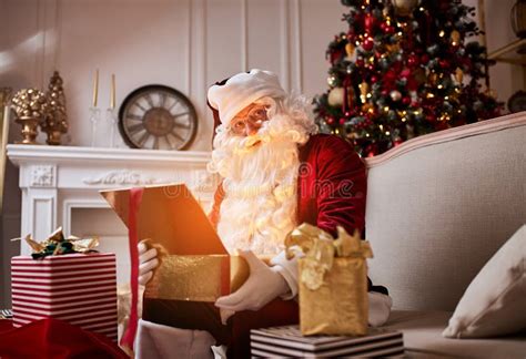 Surprised Santa Claus With A Magical Glowing Gift Near Beautiful