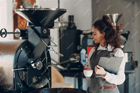 Premium Photo Coffee Roaster Machine And Barista Woman With Tablet