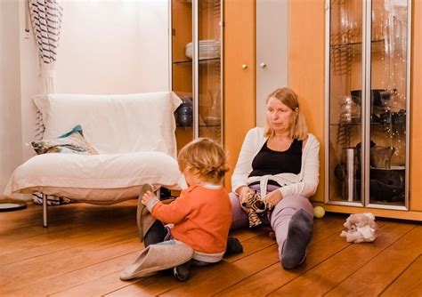 Premium Photo Grandmother And Girl Sitting On Hardwood Floor At Home