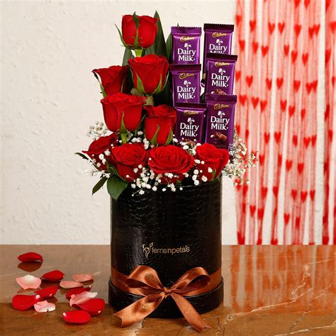 Buysend Red Roses And Dairy Milk Arrangement In Round Fnp Box Online